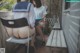 A couple of women sitting at a table on a patio.