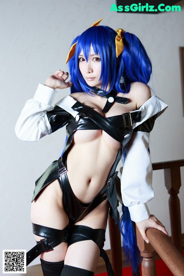 A woman with blue hair wearing a black and white outfit.