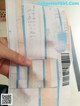 A person holding a receipt with a barcode on it.