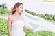 A woman in a white wedding dress with a long veil.