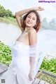 A woman in a white wedding dress posing for a picture.