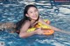 A woman in a swimming pool with an inflatable ring.