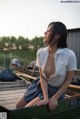 A woman sitting on top of a wooden boat.